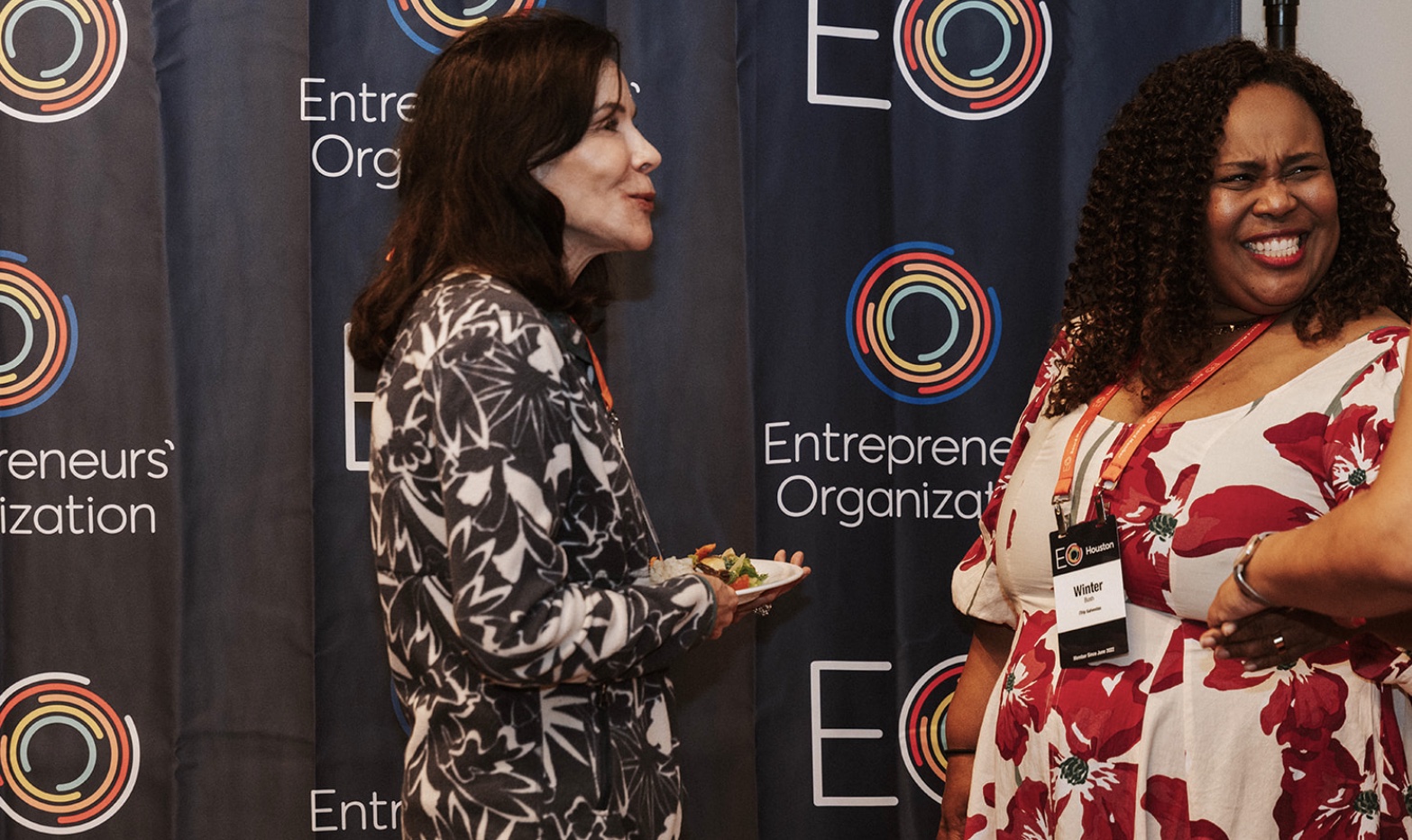 Two EO Houston members laughing together at a chapter event